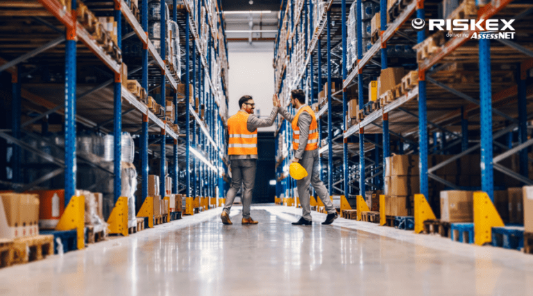 Two businessmen giving high five in a warehouse