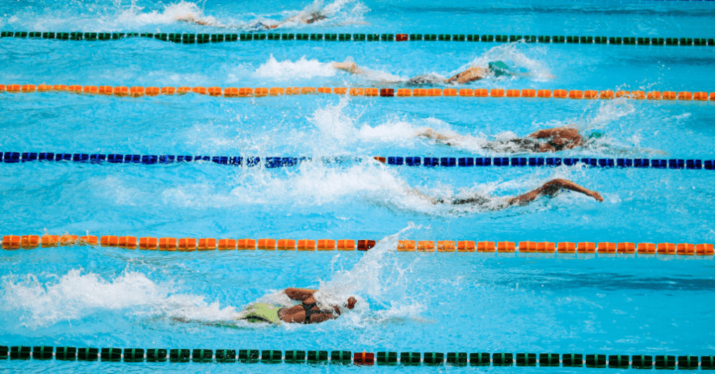 Group of swimmers doing laps in a pool.