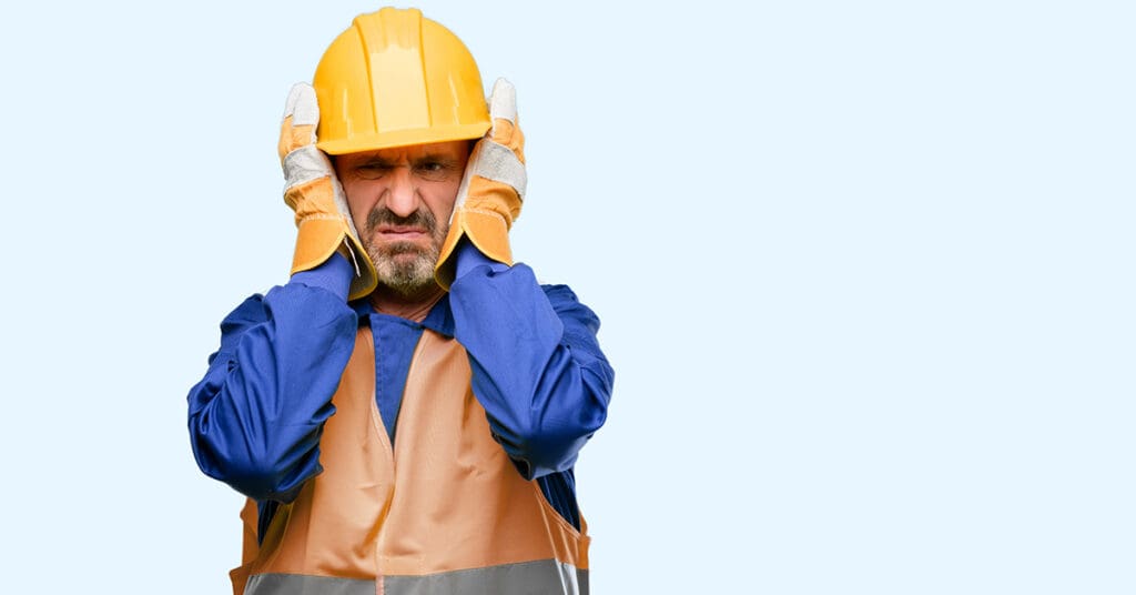 worker unhappy covering his ears.