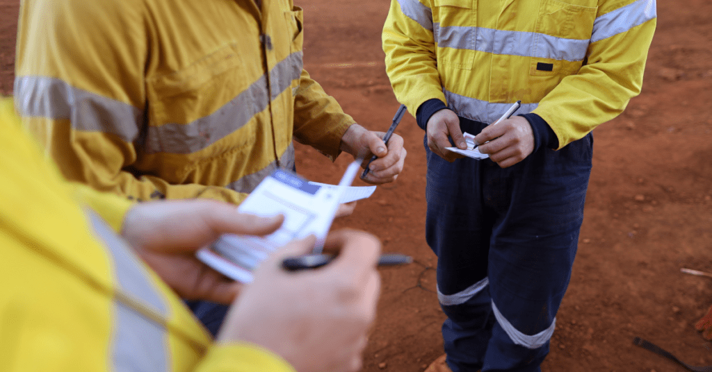 a group of men in yellow jackets carrying out risk assessment