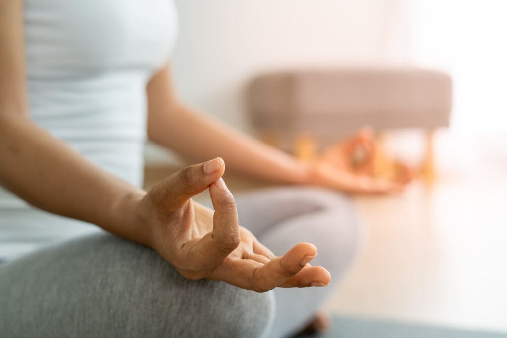 A lady meditating.