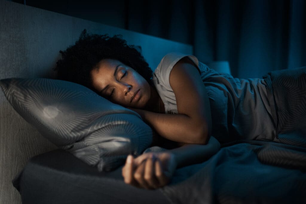 woman sleeping in her bed at night.