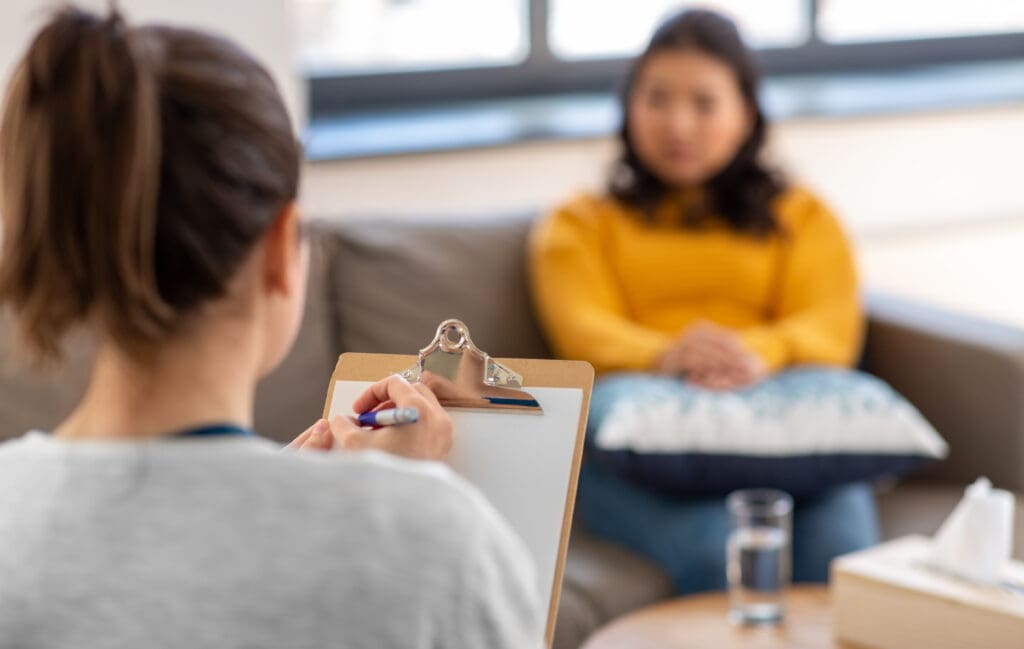lose up of woman psychologist and patient at psychotherapy session.