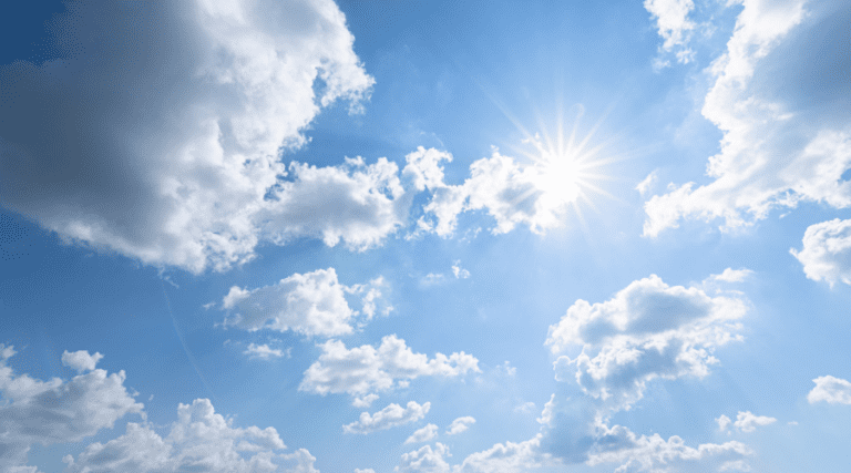 the sunny blue sky with scattered clouds.