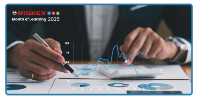 A Man using a calculator and looking at data charts.