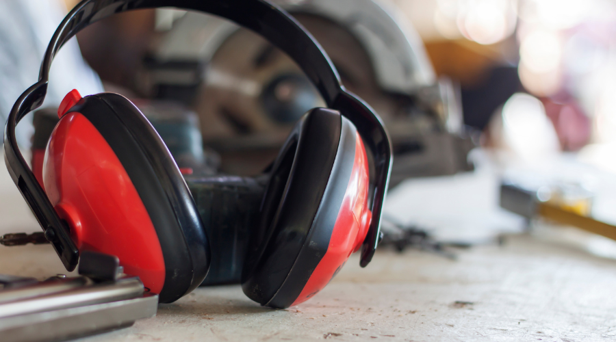 Red Ear Muffs on Wooden Table