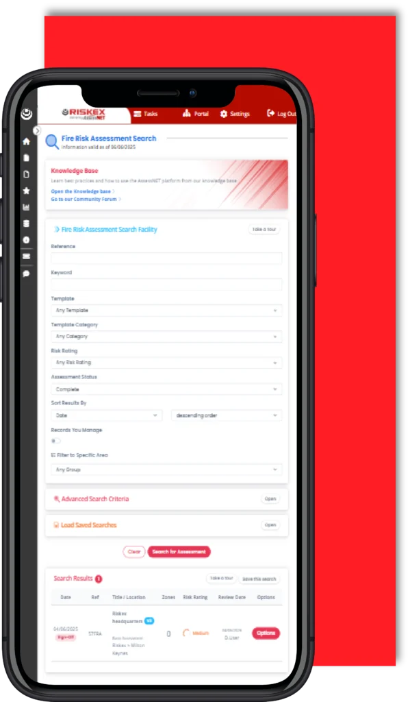 Mobile phone with a screenshot of the Fire Risk Assessment software module in AssessNET.
