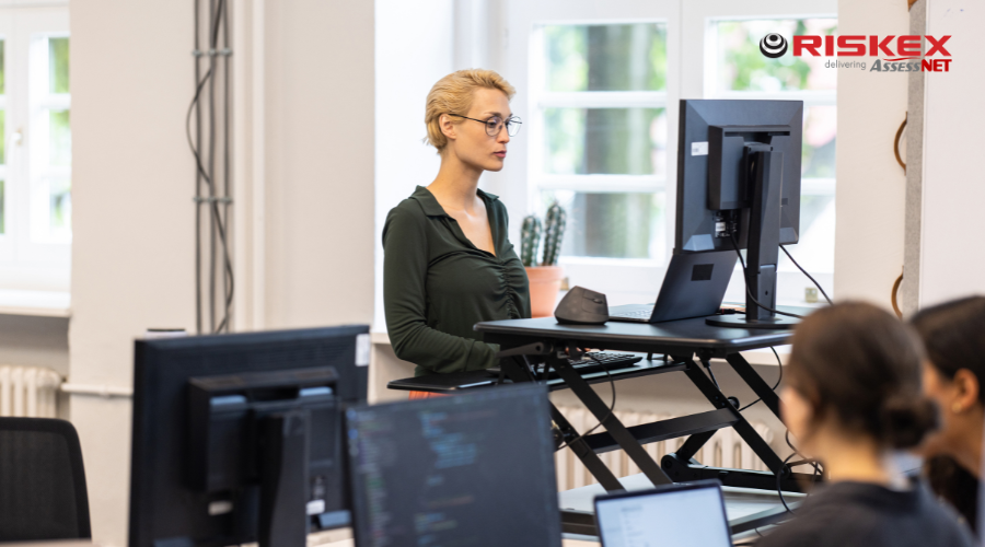 Woman working at ergonomic standing desk.