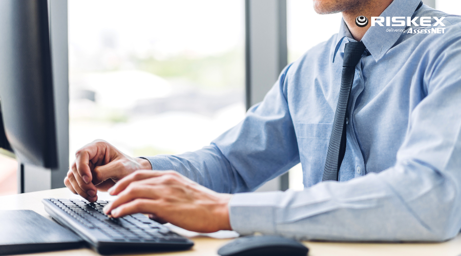 Man at his desk typing