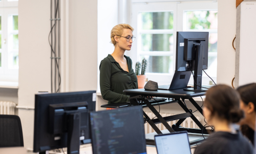 Woman working at ergonomic standing desk.