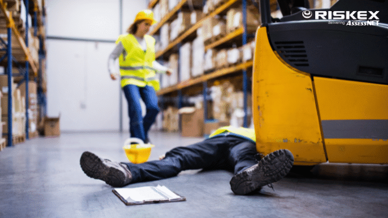 a person on a floor of a warehouse after being struck by a forklift.