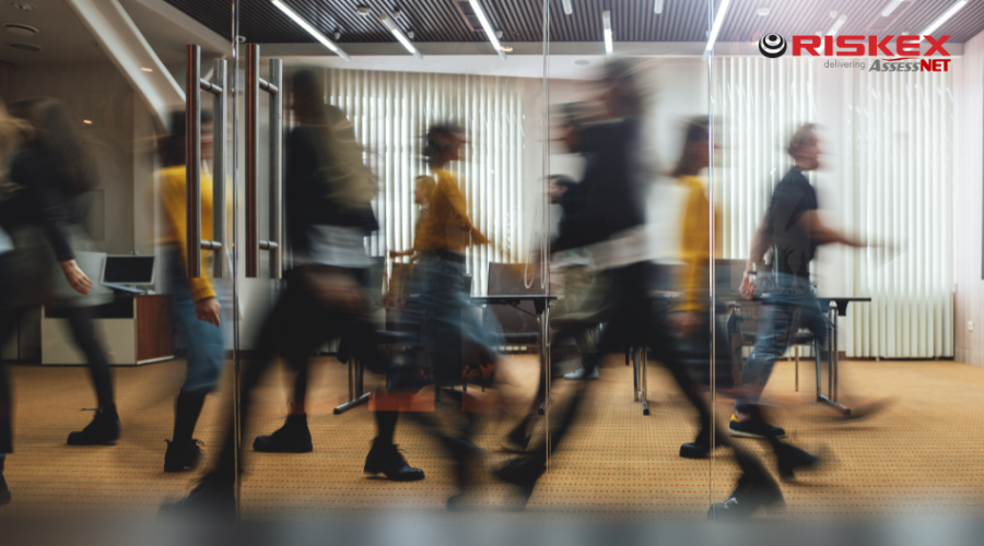 employees walking back and forth in an office.