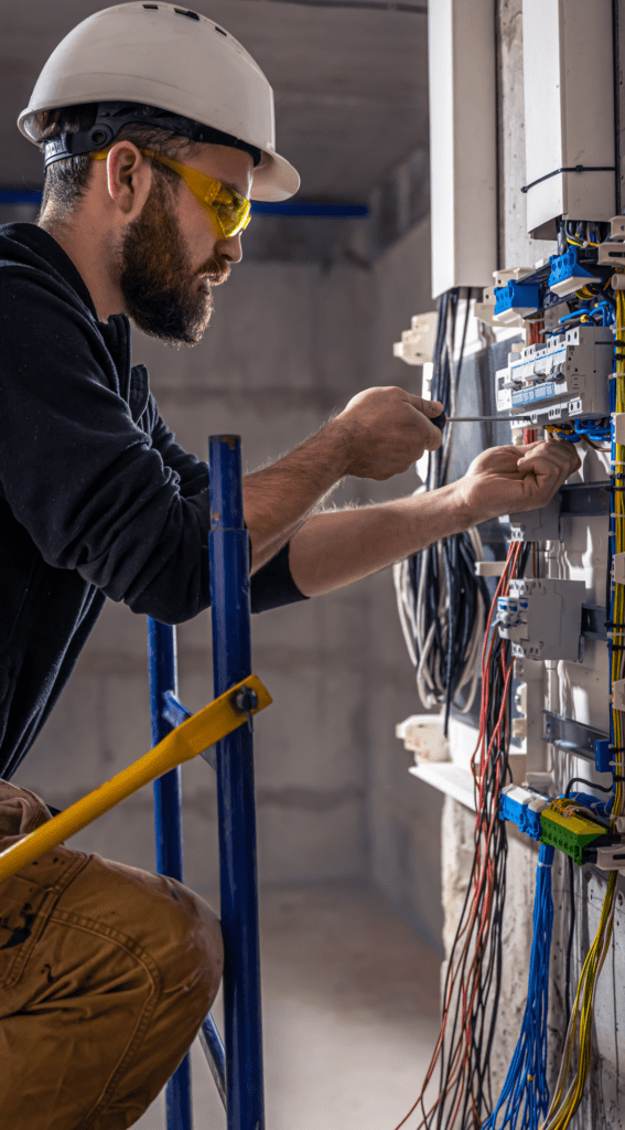 electrician working on a fuse board.