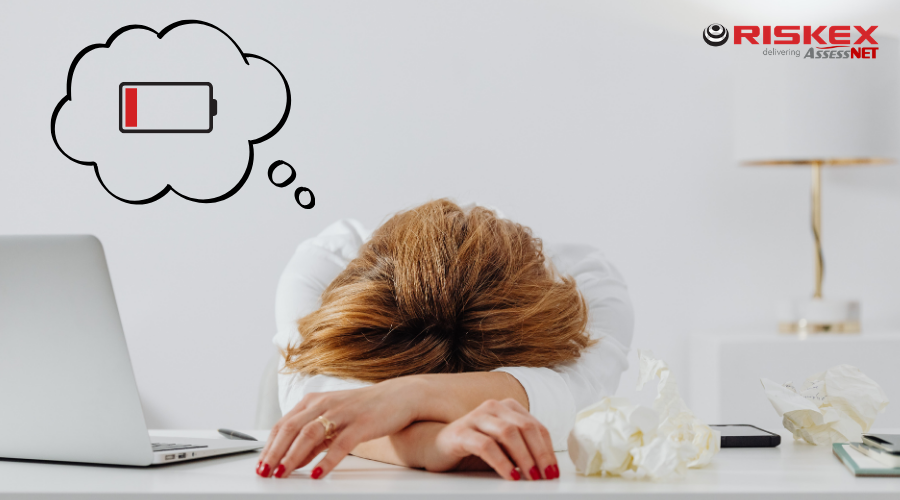 Lady exhausted with her head resting on the desk.