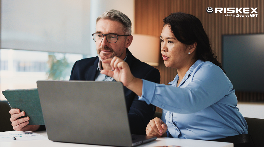 A manager and employee reviewing work together.